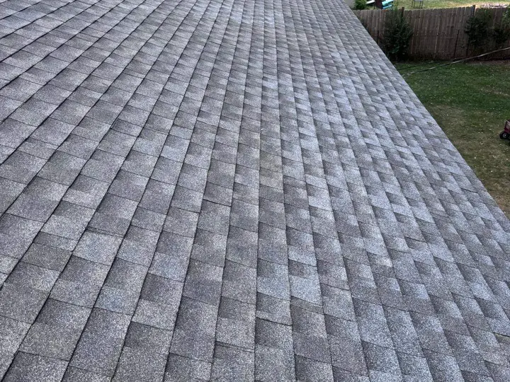Gray architectural shingles arranged across a residential roof slope