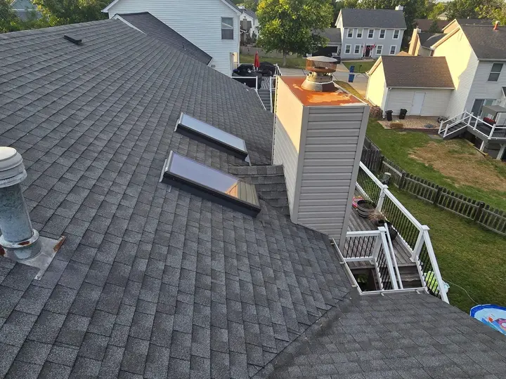 Sided chimney enclosure, skylights and vent flashing on a residential roof