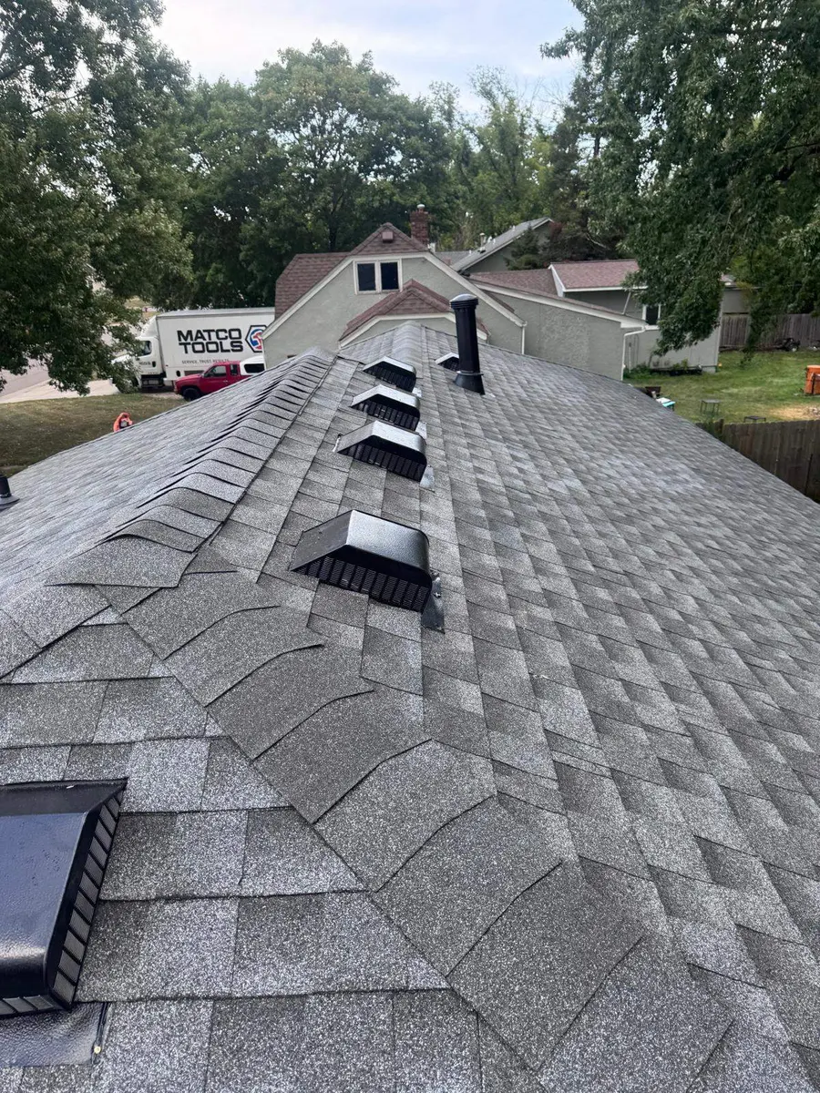 Ridge-cap shingles and roof vents photographed by Best Roofing Pros