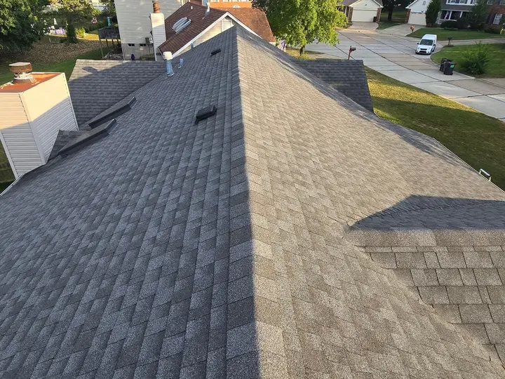 Wide view along a residential roof ridge with adjoining slopes and vents