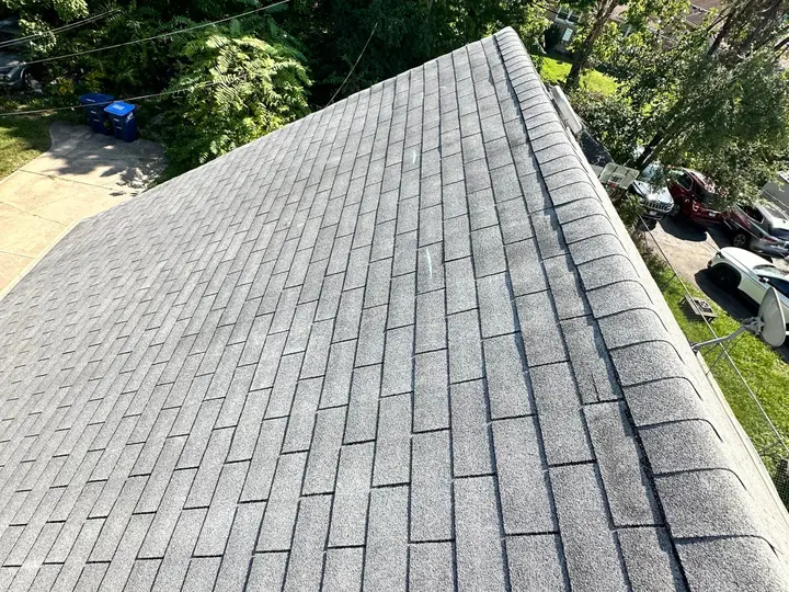 Three-tab asphalt shingles and ridge caps viewed from above